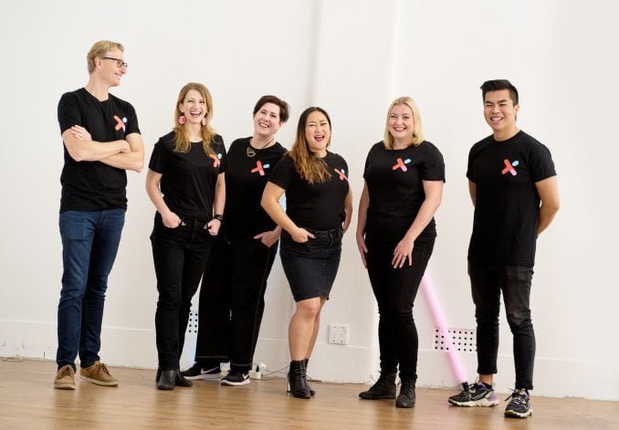 The HEX team photographed against a white backdrop, smiling at the camera